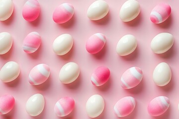 A row of eggs with white and pink paint on them