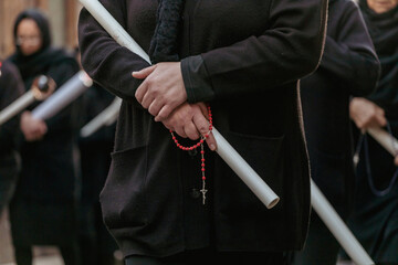 Woman Holding Candle and Rosary During Good Friday Procession in Italy
