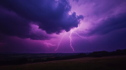Stunning purple storm clouds and lightning illuminate the night sky over the dark landscape below, creating a dramatic and eerie atmosphere.