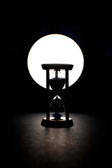 Hourglass with a flowing blue sand inside