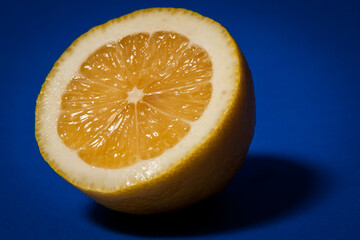 half a lemon on a blue background