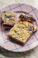 homemade blueberry lemon bars on purple grid plate