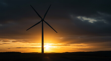 Obraz premium Wind Turbine Silhouette at Sunset: Renewable Energy Landscape