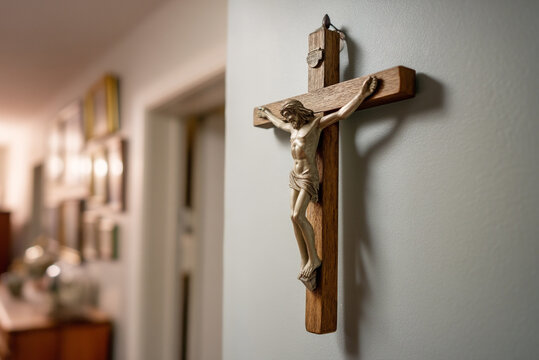 crucifix hanging on a wall with soft backlight, focus on Jesus figure.