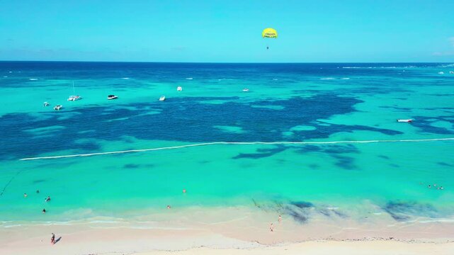 Aerial view of parasailing on tropical beach on a bright sunny day in Punta Cana