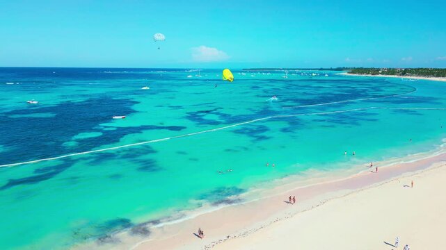 Aerial view of parasailing on tropical beach on a bright sunny day in Punta Cana
