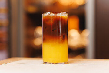 Non-alcoholic cocktails on bokeh background. Warm shades photo, multi-layered cocktails, drinks in beautiful glasses