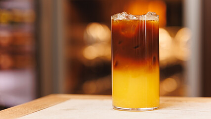 Non-alcoholic cocktails on bokeh background. Warm shades photo, multi-layered cocktails, drinks in beautiful glasses