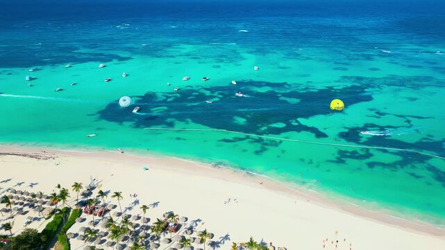 Aerial view of parasailing on tropical beach on a bright sunny day in Punta Cana