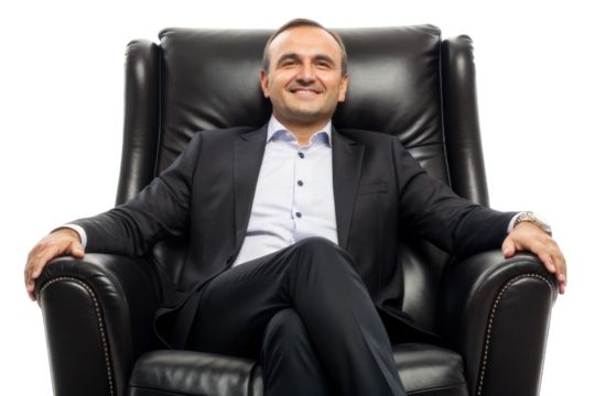 Confident businessman relaxing in an elegant leather chair with a smile in a modern office setting