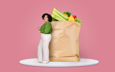 A customer is seen standing next to a large paper bag filled with fresh groceries. The individual...