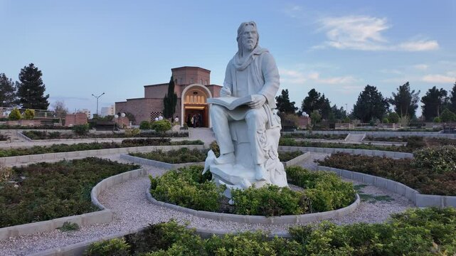 White Marble Statue Manouchehri Damghani in Iranian Garden With Blue Sky and Trees
