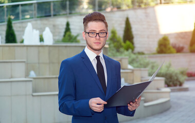 Fototapeta premium Business man holding documents. Man with glasses.