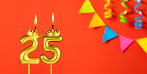 Number 25 candle - Birthday celebration on an orange background with pennants