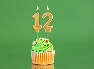 Number 12 birthday candle - Cupcake on a green background