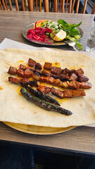 Ciger grilled liver skewers with grilled tomatoes and peppers
