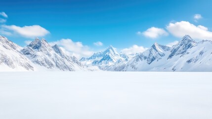 Obraz premium Snowy mountain range panorama. Pristine white expanse stretches beneath a vibrant azure sky, dotted with fluffy clouds, framed by towering snow-capped peaks