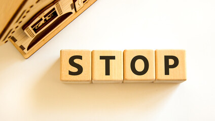 Stop symbol. Concept word Stop on beautiful wooden blocks. Beautiful wooden house. Beautiful white...