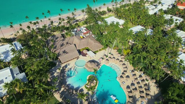 Flight around a tourist swimming pool located at an all-inclusive hotel