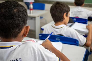 Student at school in the classroom doing activity.