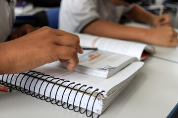 Student at school in the classroom doing activity.