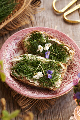 Two slices of bread with crow garlic or onion grass - wild edible plant
