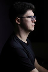 Fototapeta premium Portrait of a Man in Low Light Environment for Emotional Concept