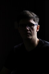 Silhouette Portrait of a Man in Low Light Environment for Emotional Concept

