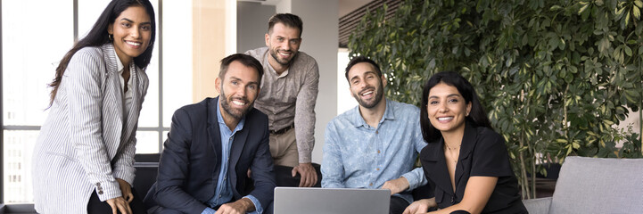 Team of diverse corporate staff members gathered in modern office, exuding professionalism,...