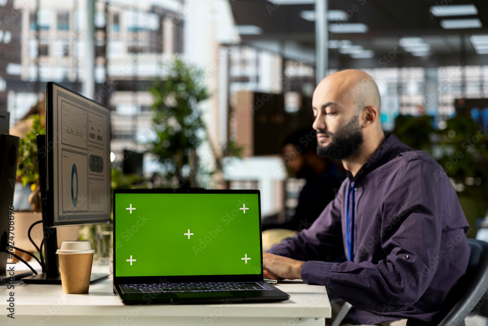 Poster young corporate analyst handling financial tasks next to chroma key display, preparing a project bri
