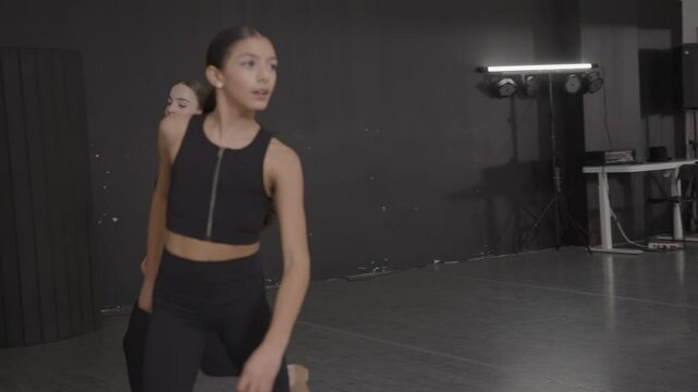 Young girls in dance class performing incredibly majestic dancing
