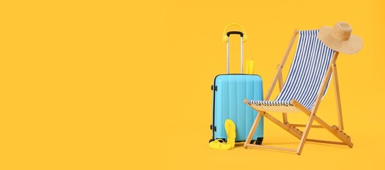 Deck chair, beach accessories and suitcase on yellow background with space for text. Summer...