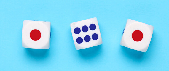 Dices with red and blue pips on blue background