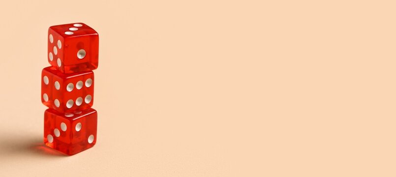 Stack of dices on beige background with space for text