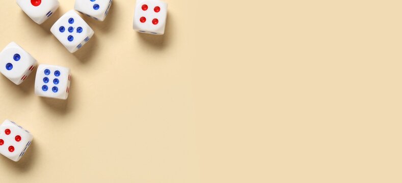 Many scattered dices on beige background with space for text, top view