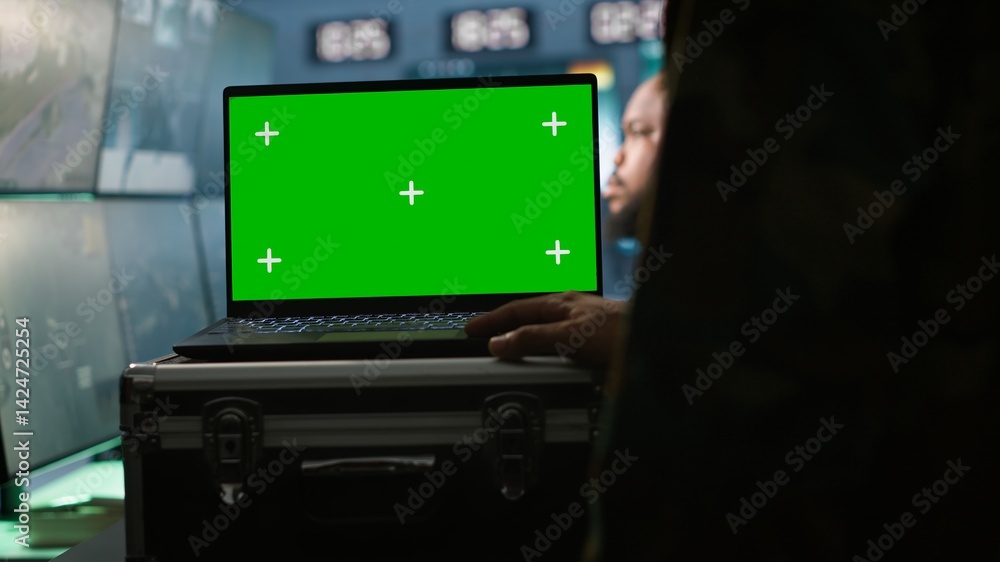 Poster military agent working in control room, using isolated screen software on laptop, analyzing aerial r
