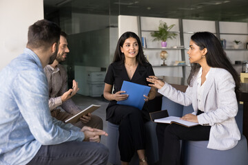 Briefing participant engaging in collaborative discussion with teammates, explain point or...