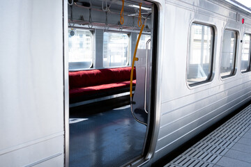 Empty parked train with seats on the side POV from outside