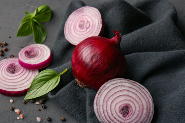 Fresh onion and spices on dark background, closeup