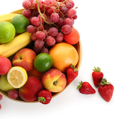 Bowl with different fresh fruits on white background