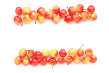 Many sweet yellow cherries on white background