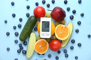 Glucometer with healthy food on blue background. Diabetes concept