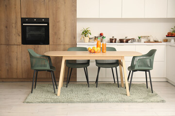 Interior of modern kitchen with wooden dining table