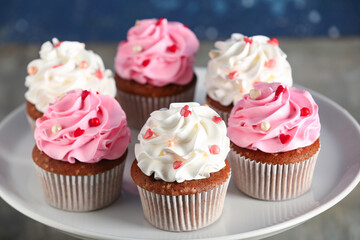 Stand with tasty cupcakes for Valentine's Day on table
