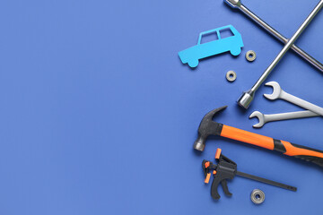 Set of mechanic instruments and paper car on blue background. Mechanic concept
