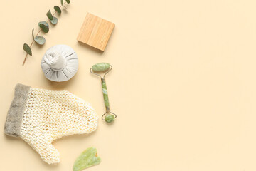 Set of spa accessories with massage glove on color background