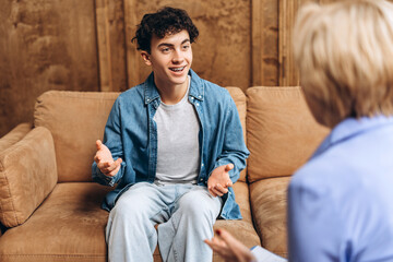 Female psychologist talking and helping male student