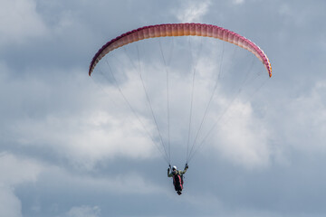 Paraglider Flying under Cloudy Sky – Aerial Adventure and Freedom in Flight