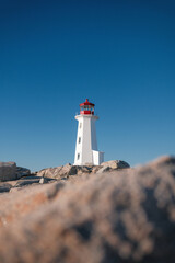 Peggy’s Cove Lighthouse in Nova Scotia, Canada, with rocky foreground and clear view of the...