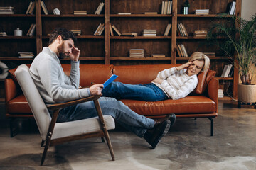 Obraz premium Sad woman and male psychiatrist shyly covering face with hands during therapy session